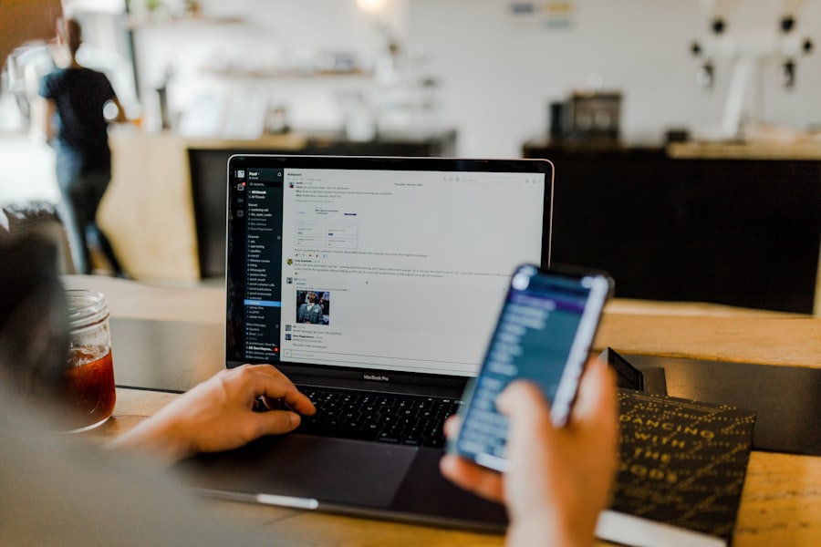 Business owner working on a laptop and phone in a cafe